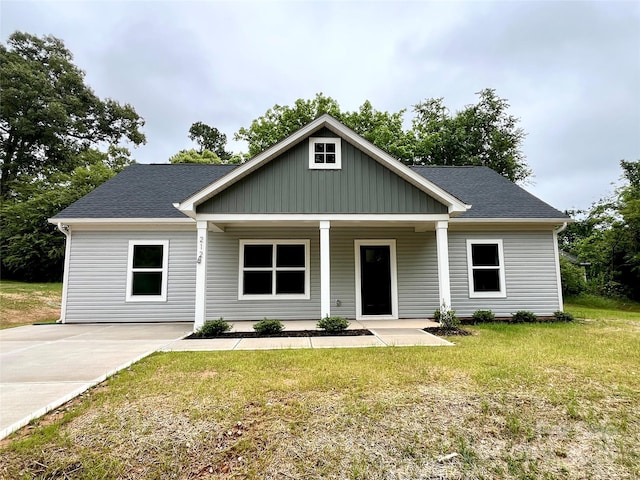 212 Queens Ct, Gastonia, NC 28052 - view of front facade with a front yard, a porch, board and batten siding, and a shingled roof
