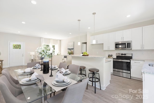 212 Queens Ct, Gastonia, NC 28052 - dining area with light wood finished floors, recessed lighting, and baseboards