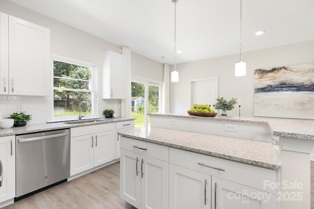 212 Queens Ct, Gastonia, NC 28052 - kitchen featuring dishwasher, a sink, tasteful backsplash, light wood-style floors, and white cabinets