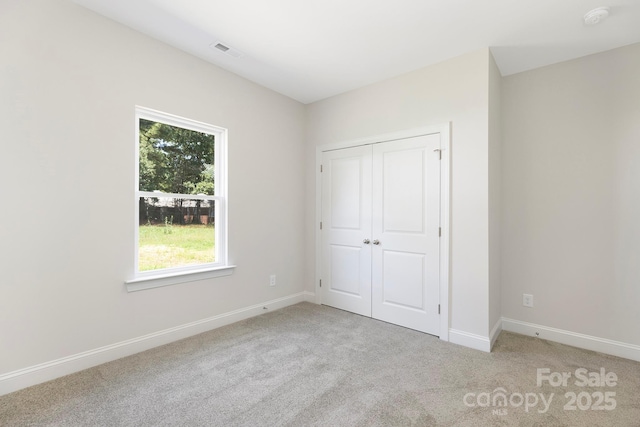 212 Queens Ct, Gastonia, NC 28052 - unfurnished bedroom featuring light carpet, baseboards, and a closet