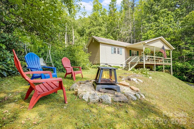 2763 Crabtree Rd, Spruce Pine, NC 28777 - rear view of house featuring a fire pit, stairway, and a wooded view