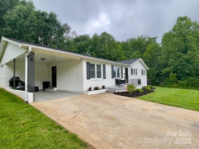 135 Michelle Dr, Ellenboro, NC 28040 - view of front of home with concrete driveway, an attached carport, and a front lawn