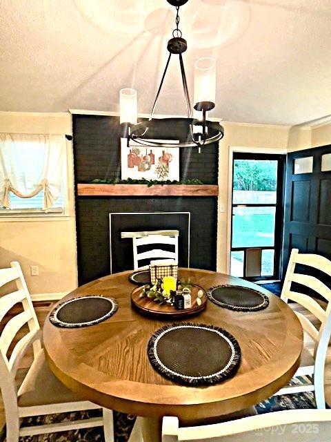 135 Michelle Dr, Ellenboro, NC 28040 - dining space with a fireplace and baseboards