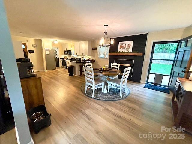 135 Michelle Dr, Ellenboro, NC 28040 - dining room with light wood-type flooring and a large fireplace