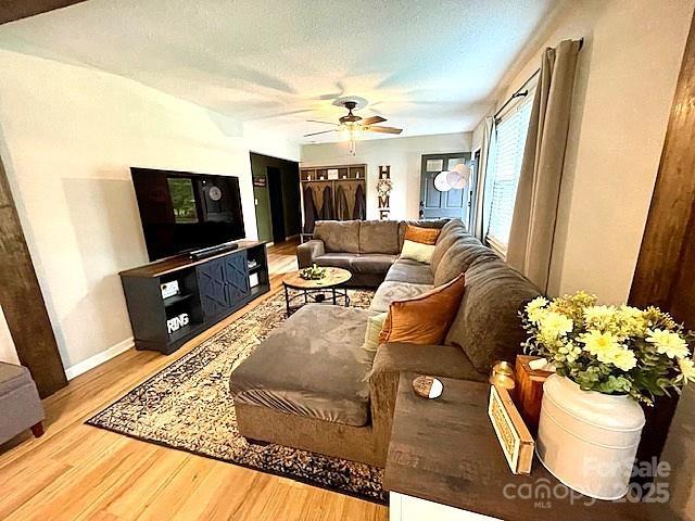 135 Michelle Dr, Ellenboro, NC 28040 - living area with wood finished floors, ceiling fan, and baseboards