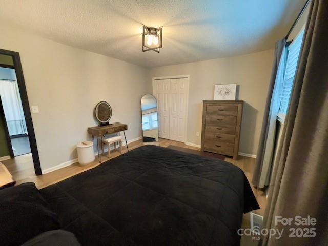 135 Michelle Dr, Ellenboro, NC 28040 - bedroom featuring wood finished floors, baseboards, and a closet
