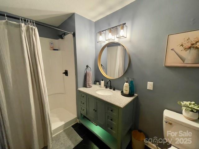 135 Michelle Dr, Ellenboro, NC 28040 - full bathroom featuring a shower with shower curtain, vanity, and toilet