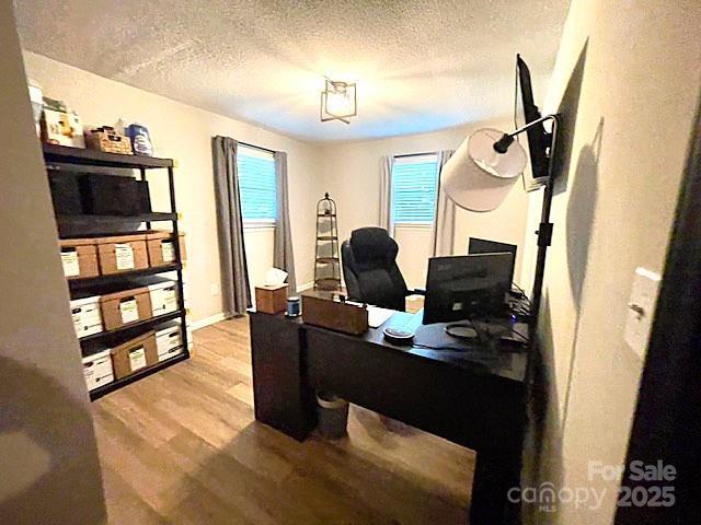 135 Michelle Dr, Ellenboro, NC 28040 - office area with wood finished floors and a textured ceiling