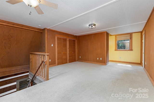 2709 Blythe Rd, Waxhaw, NC 28173 - spare room featuring wood walls, a ceiling fan, and carpet flooring
