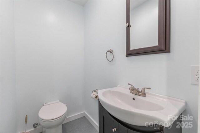 2709 Blythe Rd, Waxhaw, NC 28173 - bathroom featuring vanity, baseboards, and toilet