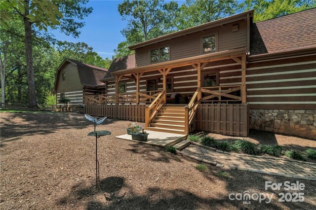 2709 Blythe Rd, Waxhaw, NC 28173 - rear view of property featuring stairway and a shingled roof