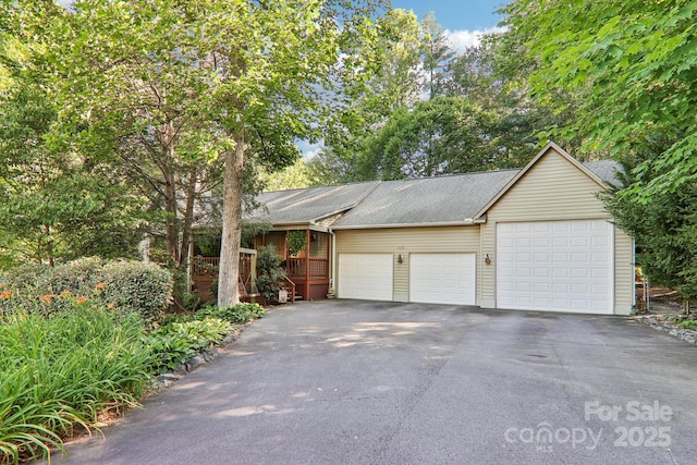 123 Brandymill Loop, Etowah, NC 28729 - view of front facade featuring an attached garage, asphalt driveway, and a shingled roof