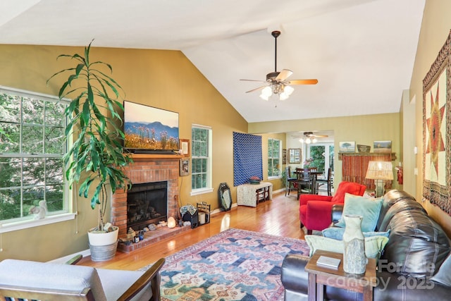 123 Brandymill Loop, Etowah, NC 28729 - living area with a ceiling fan, wood finished floors, plenty of natural light, a brick fireplace, and high vaulted ceiling