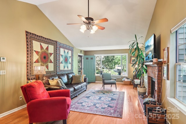 123 Brandymill Loop, Etowah, NC 28729 - living room featuring a ceiling fan, wood finished floors, a brick fireplace, and high vaulted ceiling