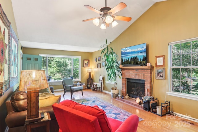 123 Brandymill Loop, Etowah, NC 28729 - living area featuring healthy amount of natural light, a fireplace, wood finished floors, and high vaulted ceiling