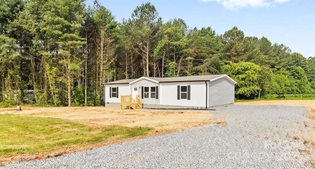 977 Myers Mill Rd, Olin, NC 28660 - manufactured / mobile home featuring a forest view and gravel driveway