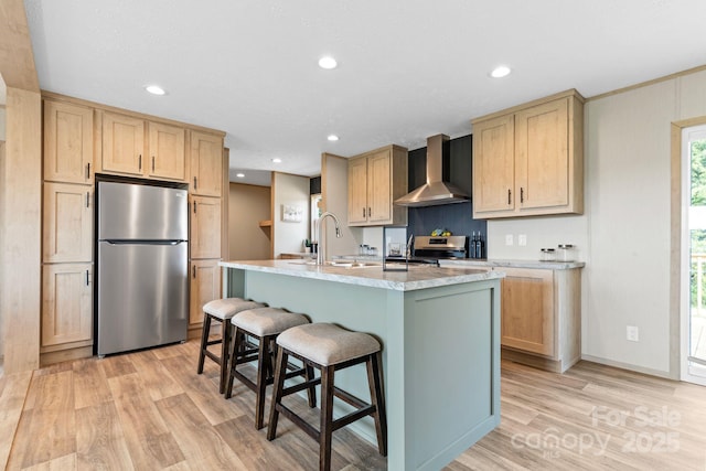 977 Myers Mill Rd, Olin, NC 28660 - kitchen with appliances with stainless steel finishes, wall chimney range hood, light brown cabinets, light wood-style floors, and recessed lighting
