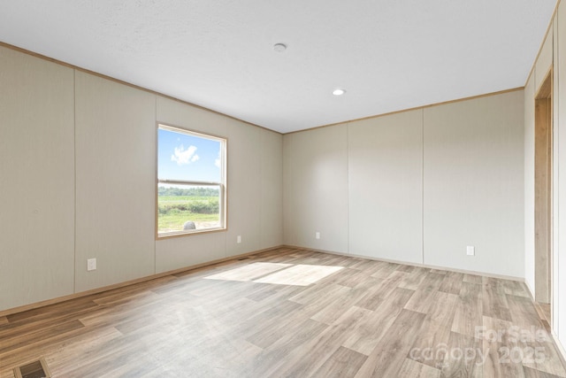 977 Myers Mill Rd, Olin, NC 28660 - empty room featuring light wood-type flooring, recessed lighting, and a decorative wall