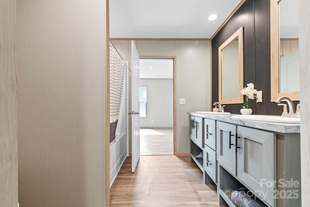 977 Myers Mill Rd, Olin, NC 28660 - bathroom featuring wood finished floors, double vanity, and shower / bath combo with shower curtain