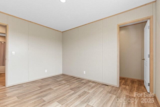977 Myers Mill Rd, Olin, NC 28660 - unfurnished bedroom with light wood finished floors and ornamental molding