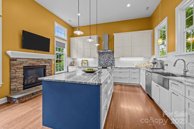 2009 Waterbury Ln, Waxhaw, NC 28173 - kitchen featuring wall chimney exhaust hood, a kitchen island, white cabinetry, tasteful backsplash, and recessed lighting