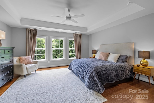 2009 Waterbury Ln, Waxhaw, NC 28173 - bedroom with a tray ceiling, wood finished floors, crown molding, and ceiling fan