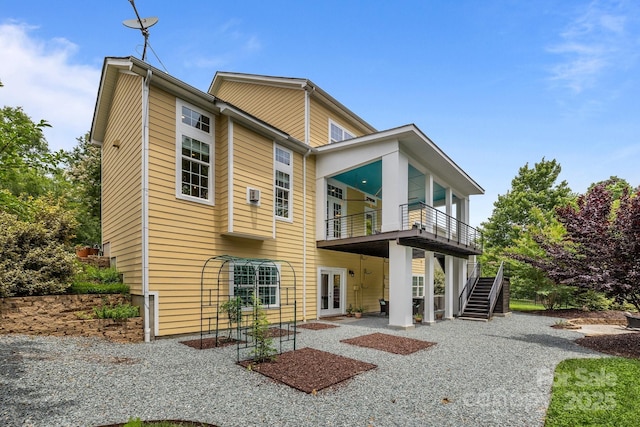 2009 Waterbury Ln, Waxhaw, NC 28173 - rear view of house featuring french doors, a patio area, a balcony, and stairway