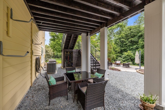2009 Waterbury Ln, Waxhaw, NC 28173 - view of patio with stairway, an outdoor fire pit, outdoor dining space, and view of scattered trees