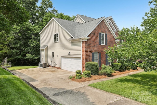 11103 Fountaingrove Dr, Charlotte, NC 28262 - view of side of home with concrete driveway, a lawn, a shingled roof, and an attached garage