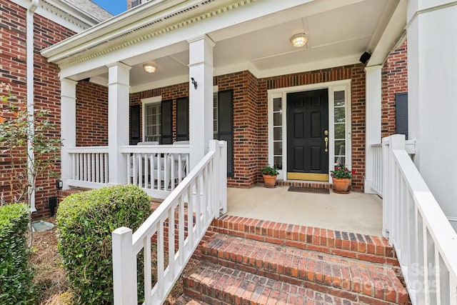 11103 Fountaingrove Dr, Charlotte, NC 28262 - view of exterior entry with brick siding and a porch
