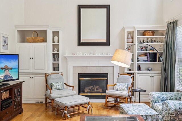 11103 Fountaingrove Dr, Charlotte, NC 28262 - living area featuring wood finished floors, a fireplace, and built in features