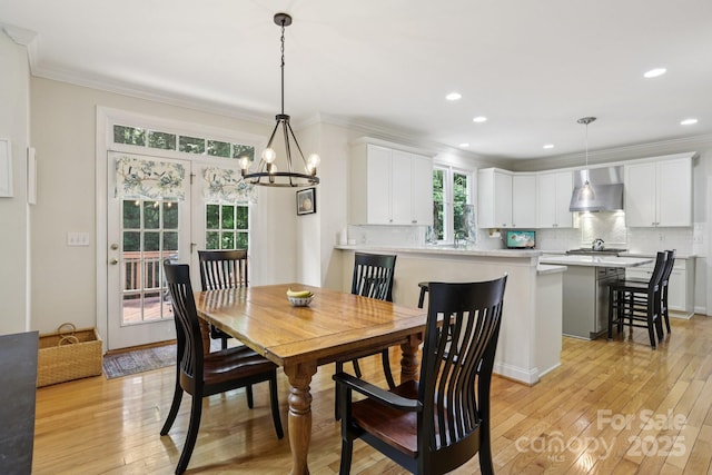 11103 Fountaingrove Dr, Charlotte, NC 28262 - dining space with ornamental molding, a chandelier, light wood-style flooring, and recessed lighting