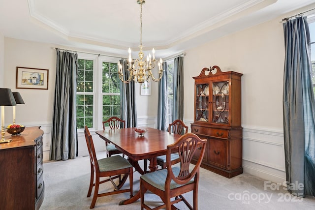 11103 Fountaingrove Dr, Charlotte, NC 28262 - dining area with a chandelier, light colored carpet, a raised ceiling, ornamental molding, and wainscoting