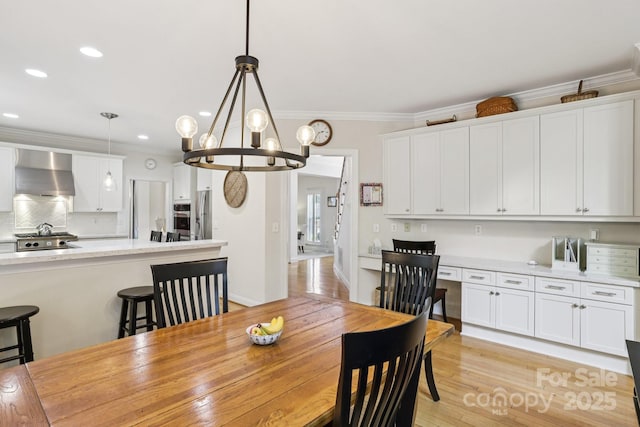 11103 Fountaingrove Dr, Charlotte, NC 28262 - dining room with a chandelier, crown molding, recessed lighting, and light wood-style flooring