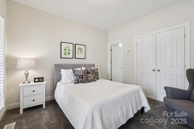 11103 Fountaingrove Dr, Charlotte, NC 28262 - bedroom with dark colored carpet, a closet, and baseboards