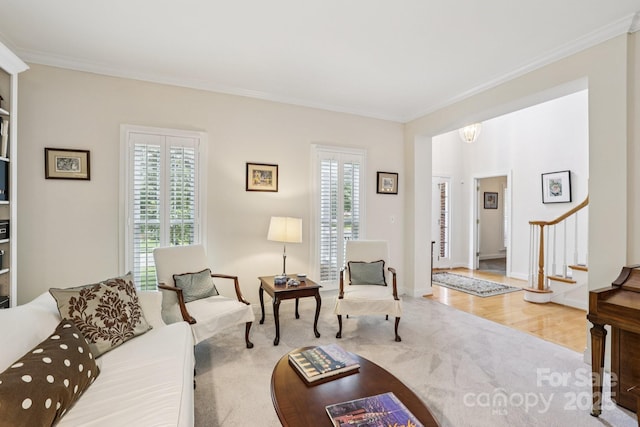 11103 Fountaingrove Dr, Charlotte, NC 28262 - living area with carpet flooring, crown molding, stairway, a chandelier, and baseboards