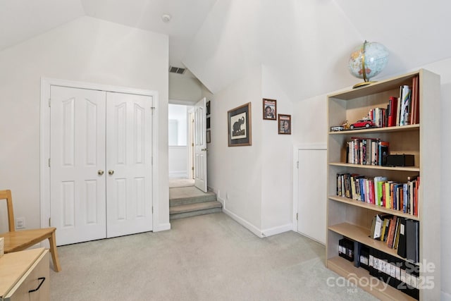11103 Fountaingrove Dr, Charlotte, NC 28262 - living area featuring lofted ceiling, carpet flooring, and baseboards