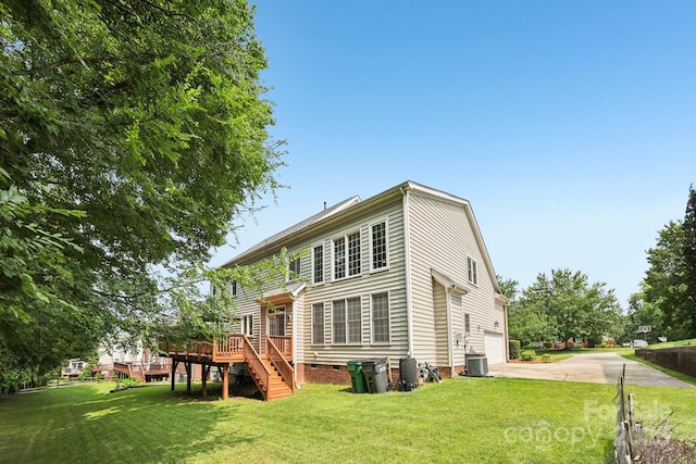 11103 Fountaingrove Dr, Charlotte, NC 28262 - back of property with driveway, stairs, a deck, and a lawn
