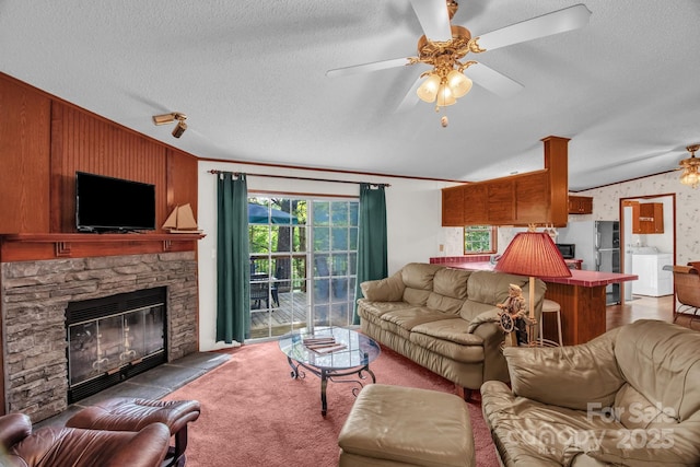 7232 Executive Cir, Denver, NC 28037 - carpeted living room featuring a textured ceiling, a ceiling fan, lofted ceiling, a stone fireplace, and crown molding