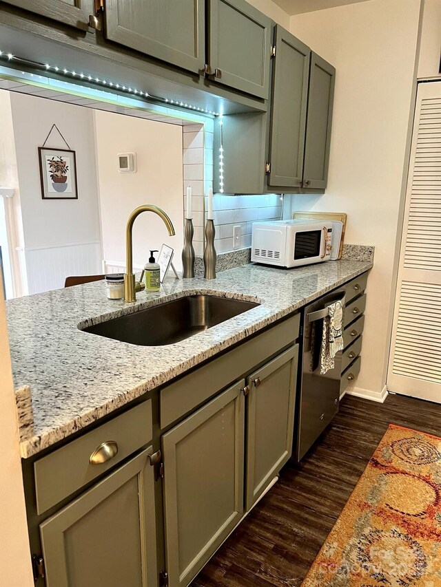 229 Windsor Point Rd Unit 6D, Columbia, SC 29223 - kitchen featuring white microwave, a sink, dark wood-style flooring, stainless steel dishwasher, and light stone counters