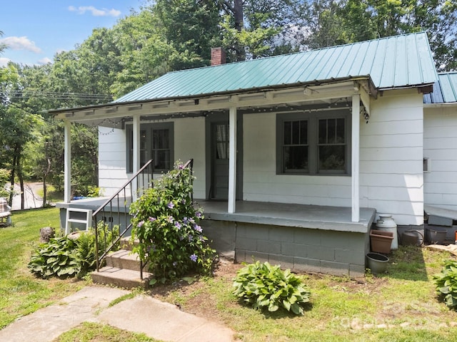 6 Willies Hl, Fletcher, NC 28732 - bungalow featuring a chimney, a porch, metal roof, and a front lawn