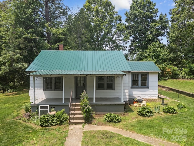 6 Willies Hl, Fletcher, NC 28732 - view of front of property with a porch, a front lawn, metal roof, and a chimney