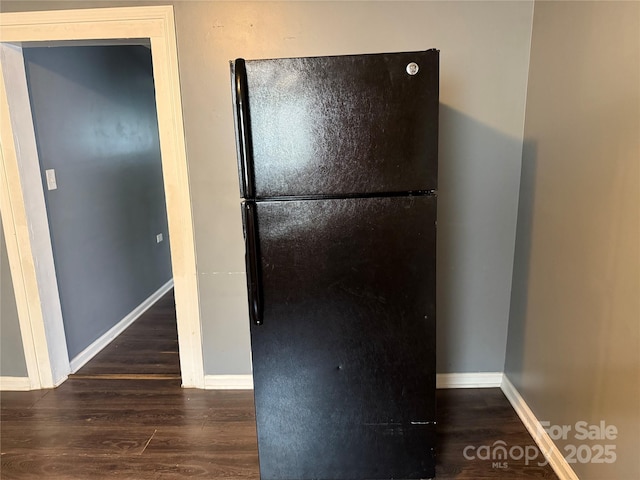 303 Southern Ave, East Spencer, NC 28039 - detailed view of freestanding refrigerator, baseboards, and wood finished floors