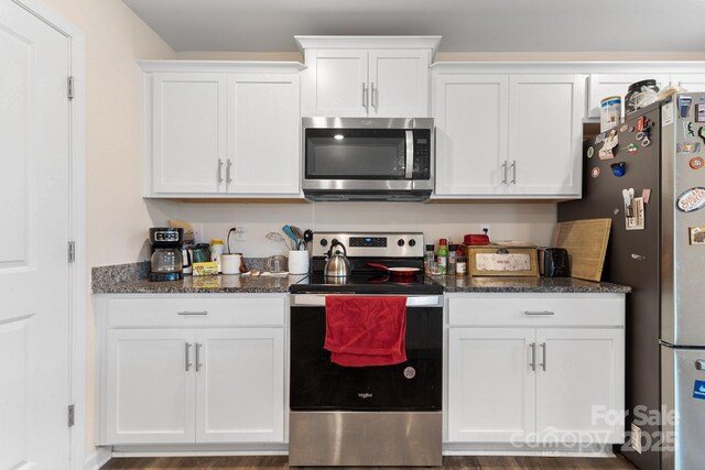 2859 Sherrills Stream Dr, Sherrills Ford, NC 28673 - kitchen with appliances with stainless steel finishes, white cabinets, dark stone countertops, and dark wood finished floors