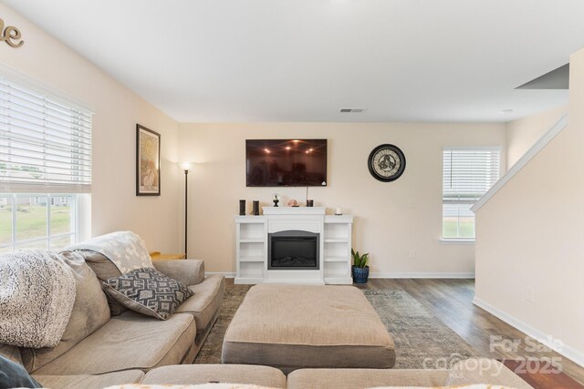 2859 Sherrills Stream Dr, Sherrills Ford, NC 28673 - living room with wood finished floors, baseboards, and a glass covered fireplace