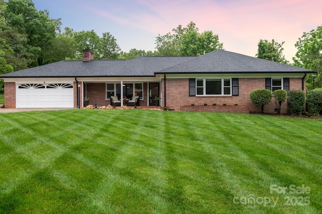 306 Tremont Park Cir SE, Lenoir, NC 28645 - single story home with a garage, brick siding, a front lawn, and a chimney