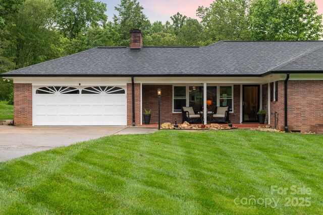306 Tremont Park Cir SE, Lenoir, NC 28645 - single story home featuring covered porch, driveway, roof with shingles, a chimney, and a lawn