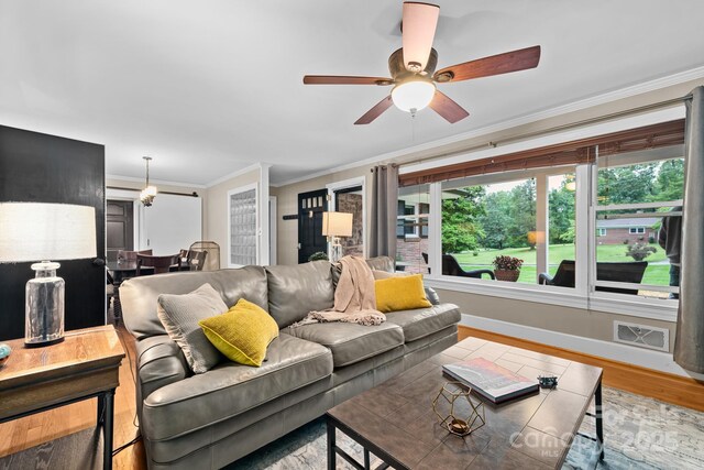 306 Tremont Park Cir SE, Lenoir, NC 28645 - living room featuring wood finished floors, ceiling fan, ornamental molding, and baseboards