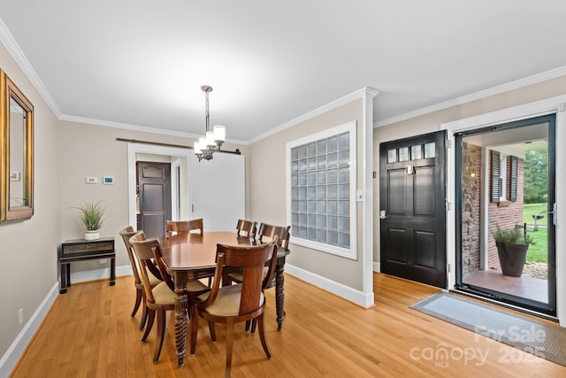 306 Tremont Park Cir SE, Lenoir, NC 28645 - dining room featuring baseboards, light wood finished floors, crown molding, and a chandelier