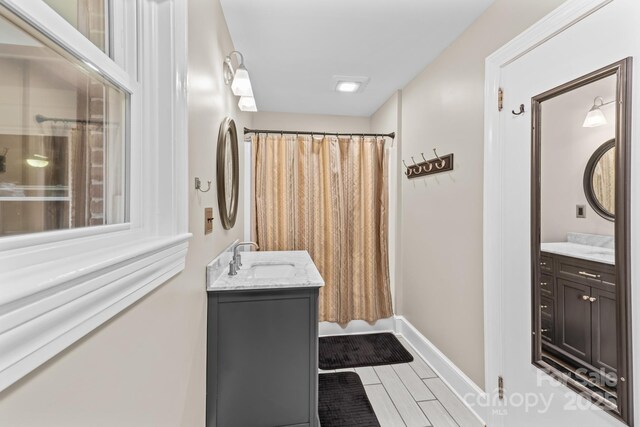 306 Tremont Park Cir SE, Lenoir, NC 28645 - full bathroom with vanity, a shower with shower curtain, and baseboards